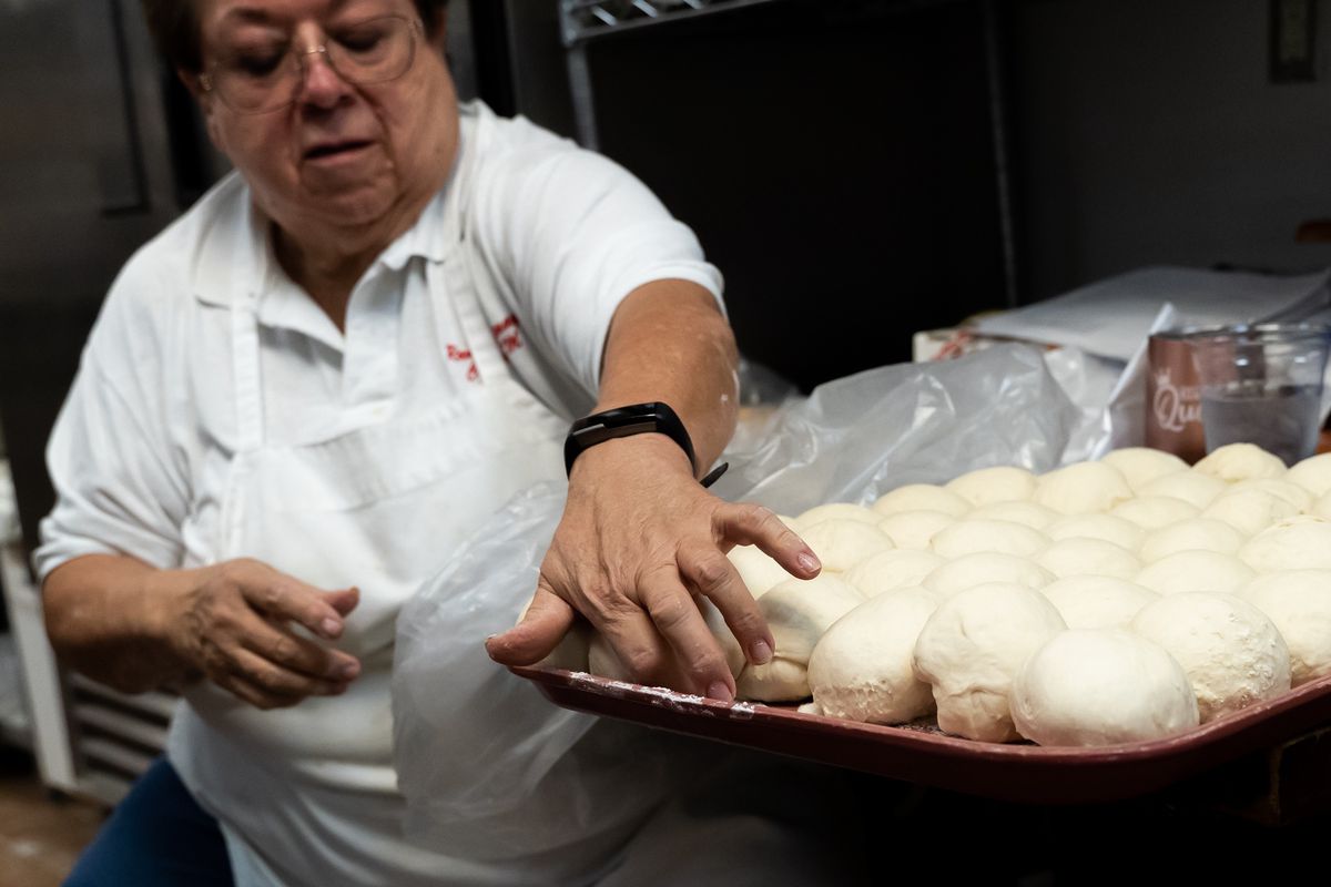 A chef shapes balls of sopaipilla dough.
