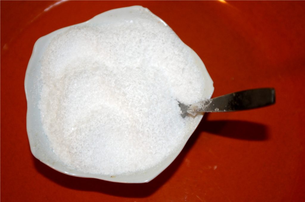 A small bowl of coarse kosher salt with herbs
