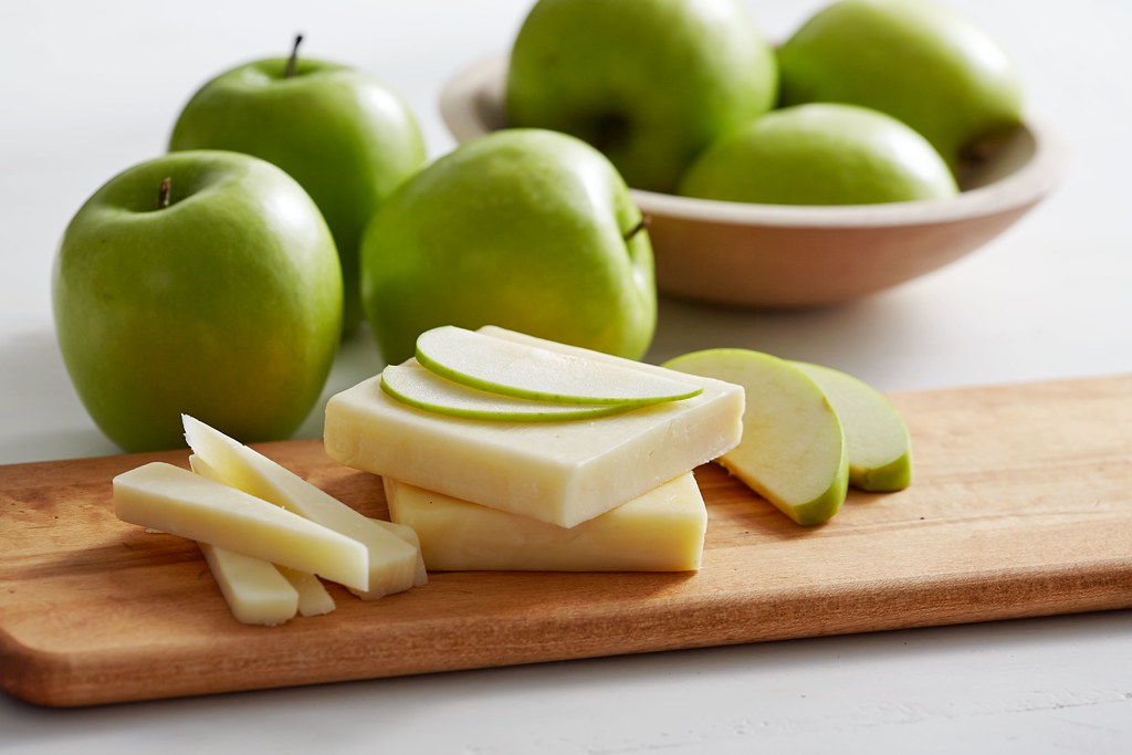 Sliced Granny Smith apples on a wooden cutting board