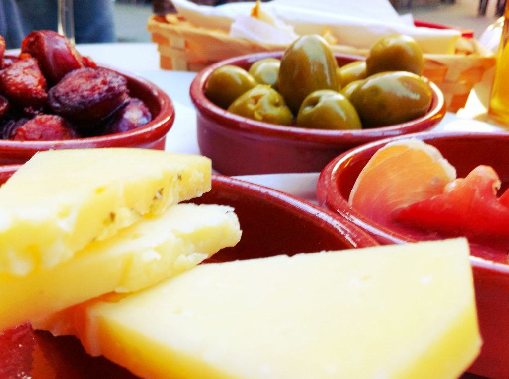 Several small plates of food shared on a table