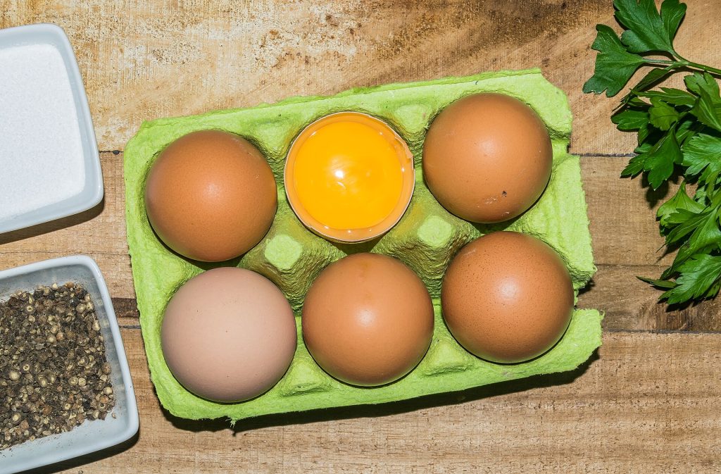 A carton of brown eggs on a kitchen counter