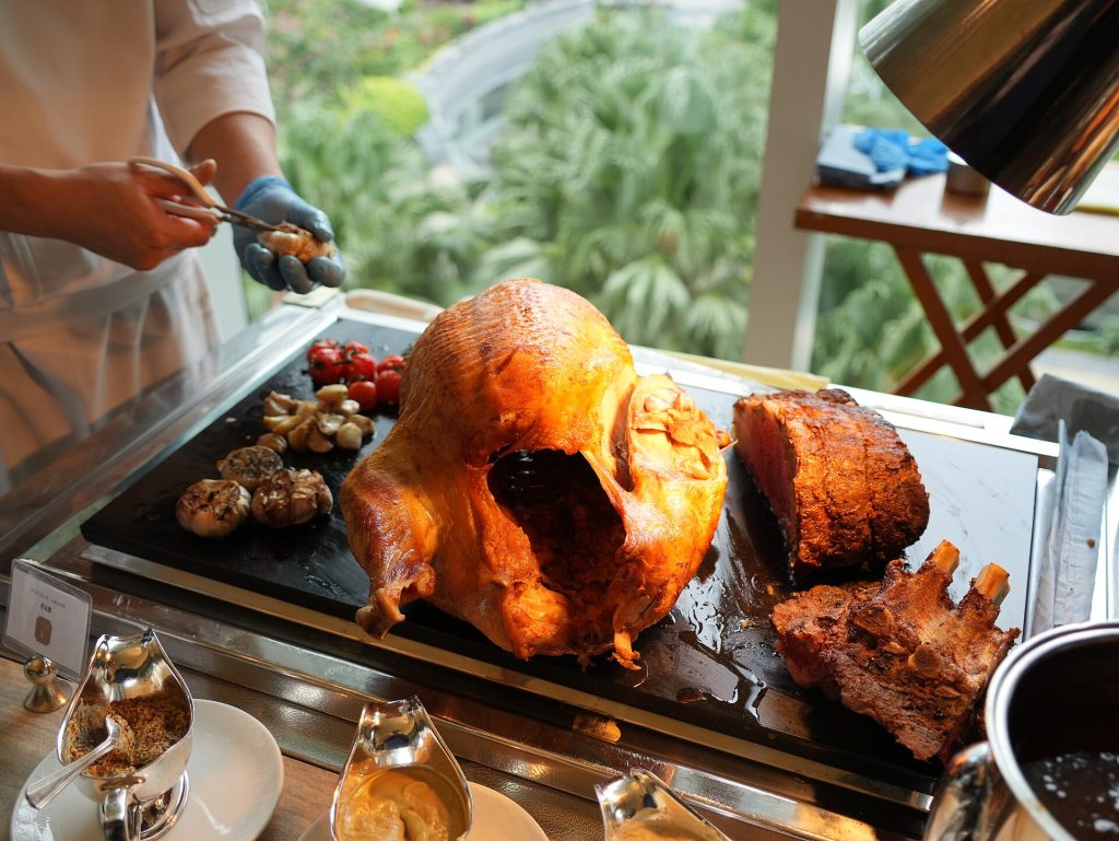 A whole roast turkey on a platter ready to be carved