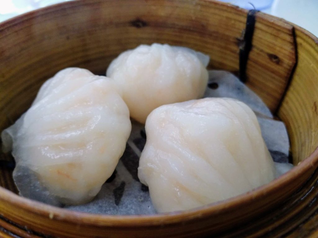 Bamboo steamer baskets filled with assorted dim sum on a table