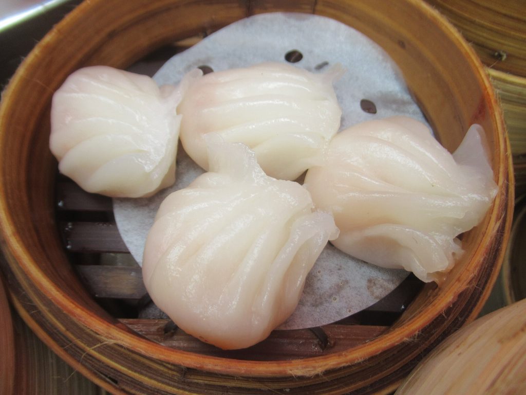 Translucent har gow shrimp dumplings in a steamer basket
