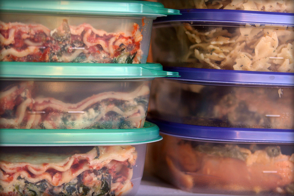 Leftovers stored in shallow containers in a refrigerator