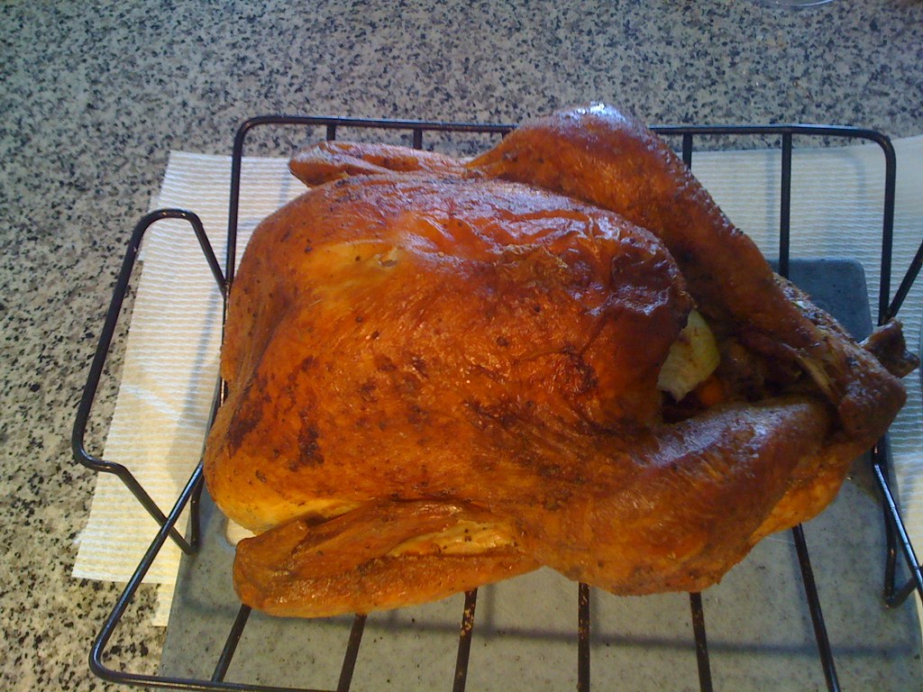 A food thermometer checking the temperature of roast chicken