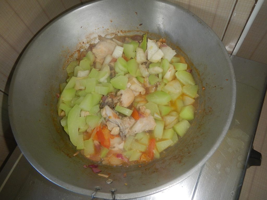 A bowl of turkey noodle soup with vegetables