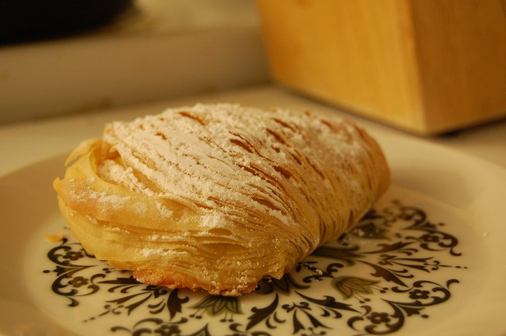 Flaky shell-shaped sfogliatella pastries on a tray