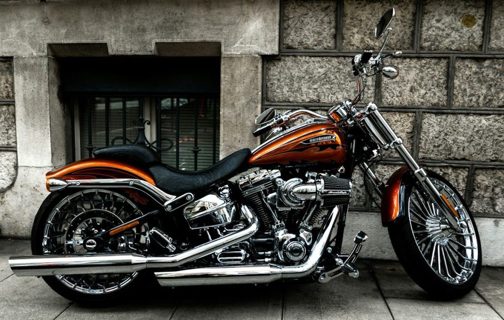 Brown and black cruiser motorcycle parked outdoors